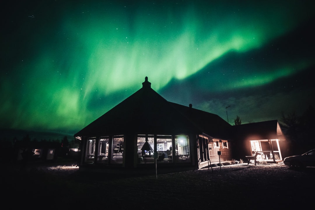 Main Building & Restaurant Loimu under the northern lights Aurora Village Ivalo Lapland Finland.