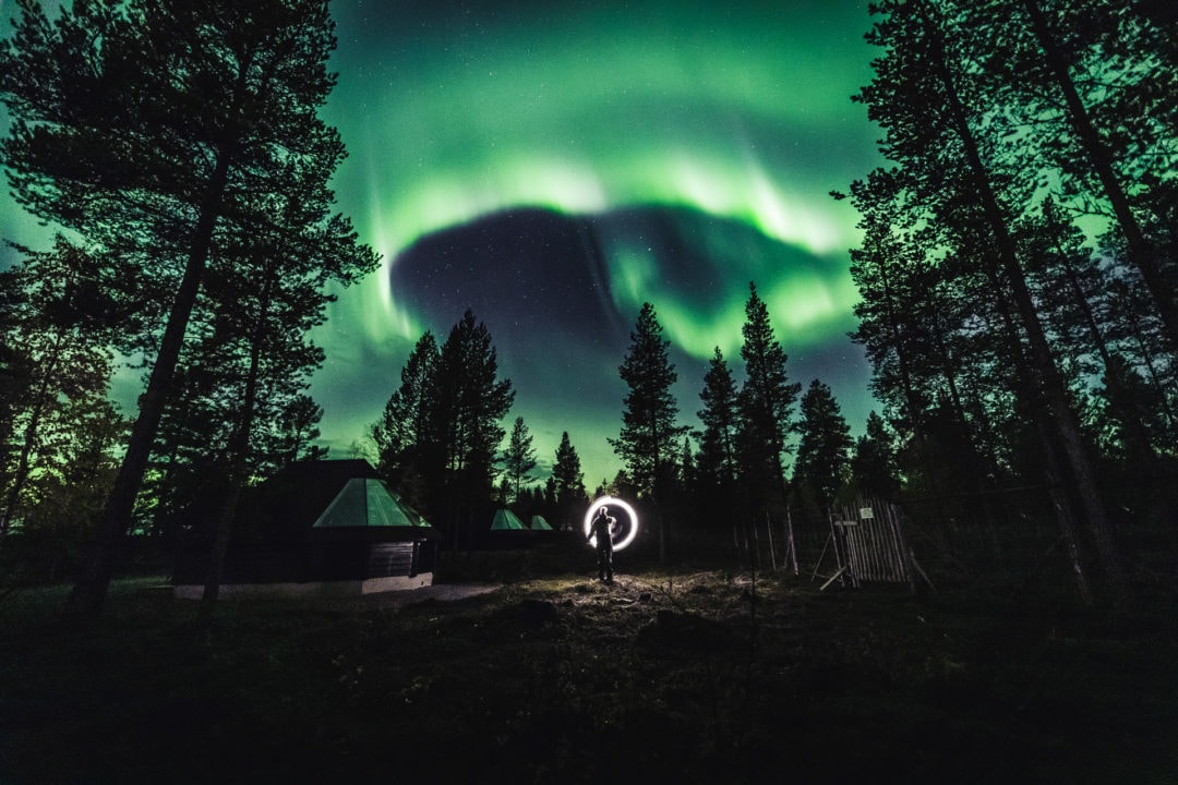 Northern Lights Glowing in the dark at the Aurora Village cottages in Ivalo Lapland Finland. Photo by Alex / All About Lapland.
