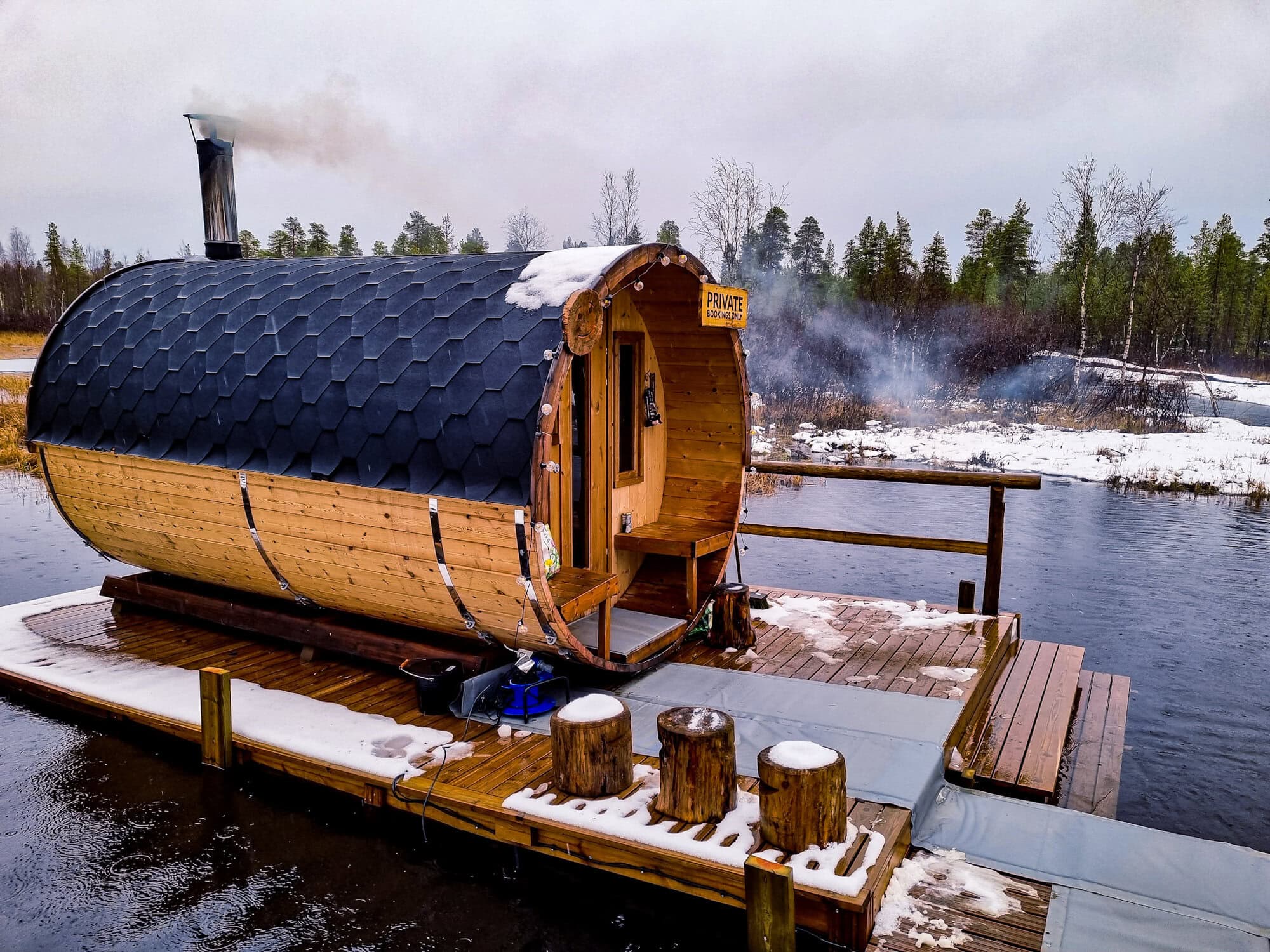 Wood-fired barrel sauna beside the water at Aurora Village Ivalo on 1 November 2020