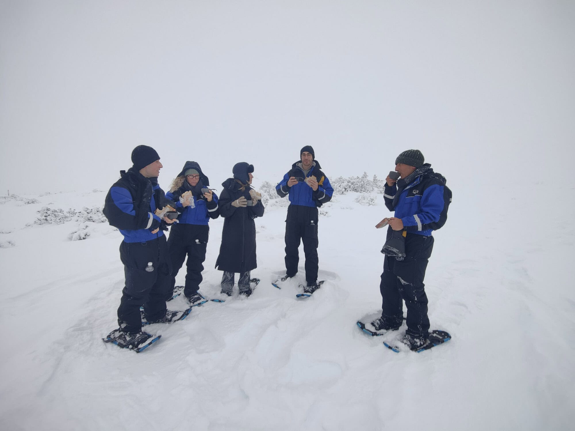 Guests taking a break on a snowshoe tour in deep snow on 5 November 2023