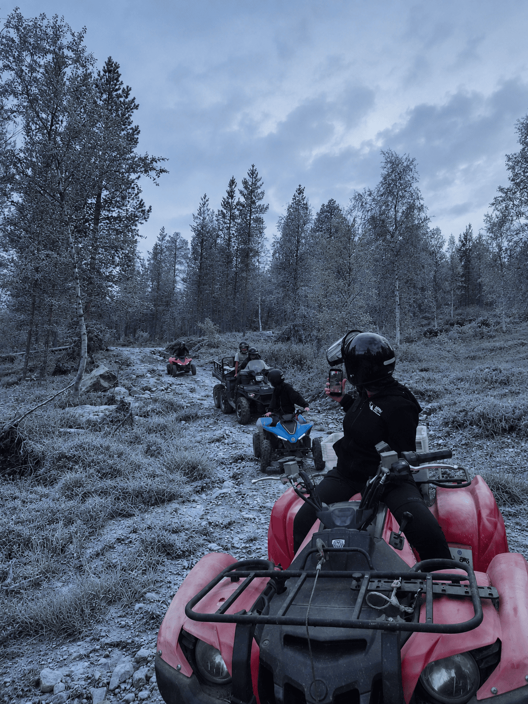 Guests riding ATVs along a lightly frosted forest trail on 12 November 2024